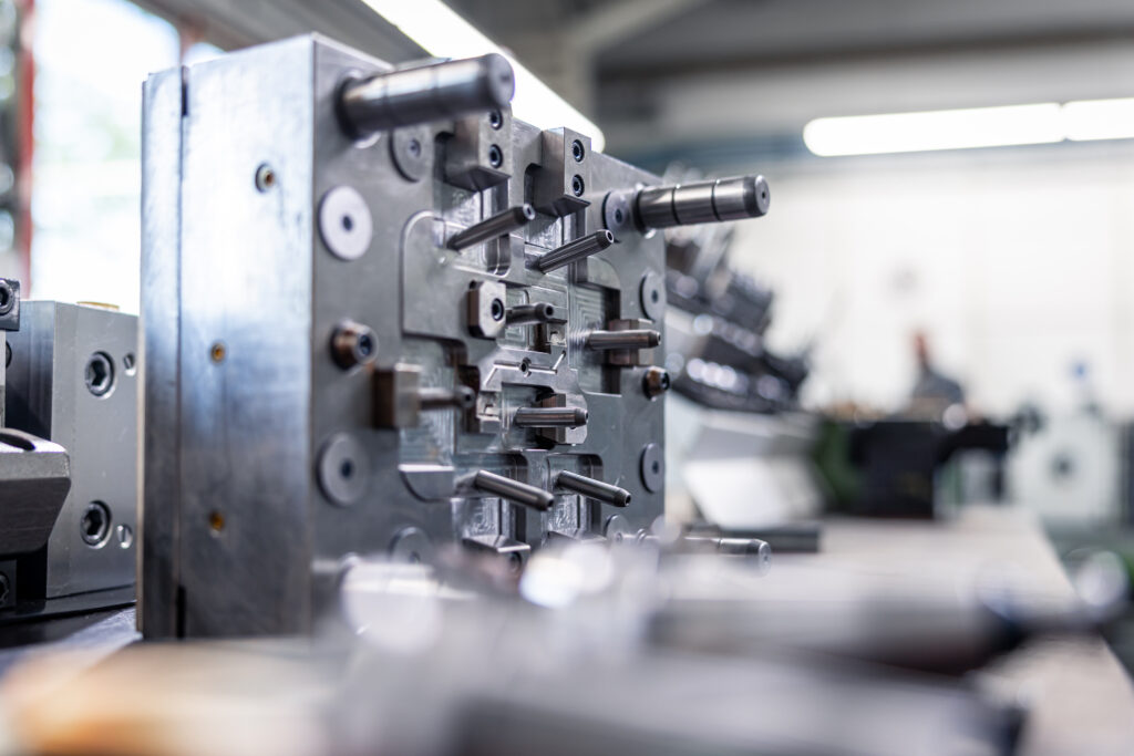 A precise metal injection mold stands in a workshop at Schröder and Heidler for plastics processing.